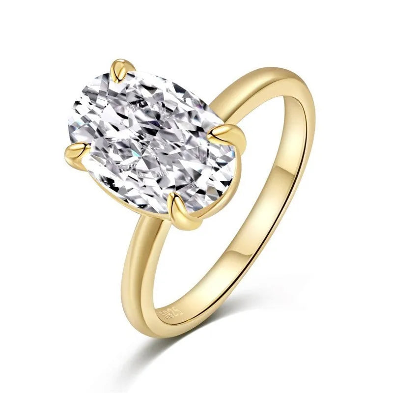 Oval sterling silver women's ring with four-claw setting and hand-cut gemstone.