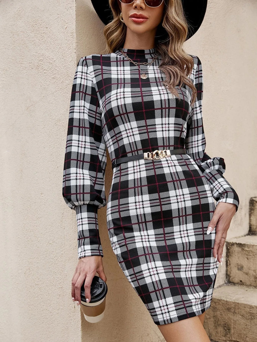 Black women's tight dress with lantern sleeves and leather stitching detail