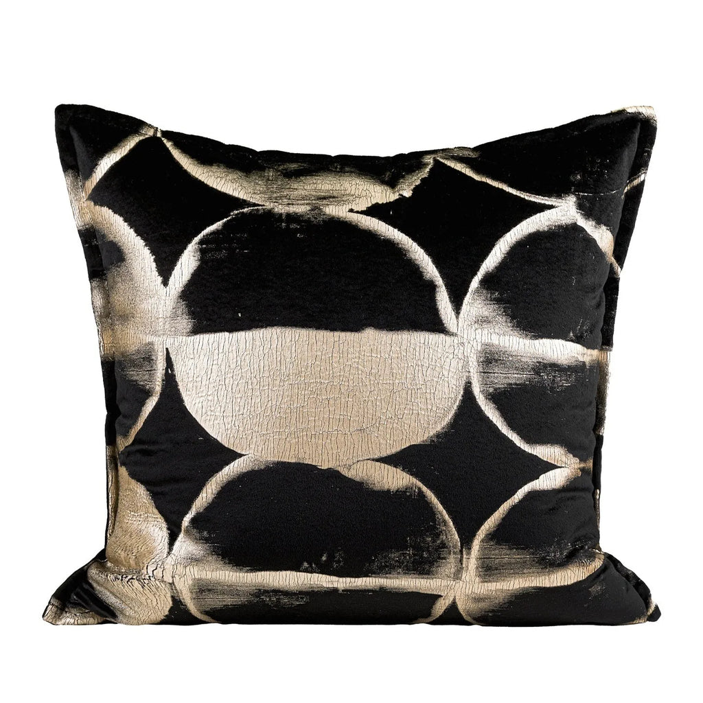 Black and gold abstract pattern flannel pillow cover on a grey sofa.
