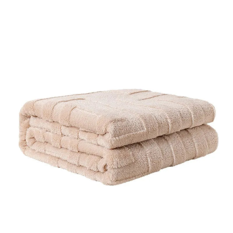 Thick square coral fleece flannel blanket in brown colour shown folded on a sofa