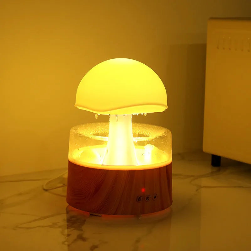 White cloud-shaped humidifier emitting mist with LED lights and falling water droplets