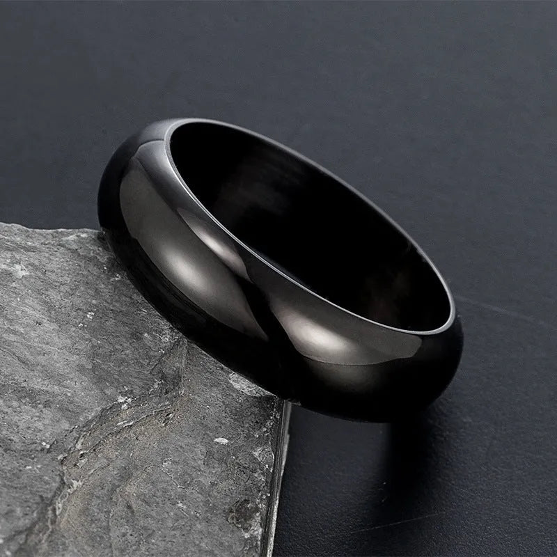A glossy electroplated titanium steel ring shown in gold, black, and steel colour options on a plain background.