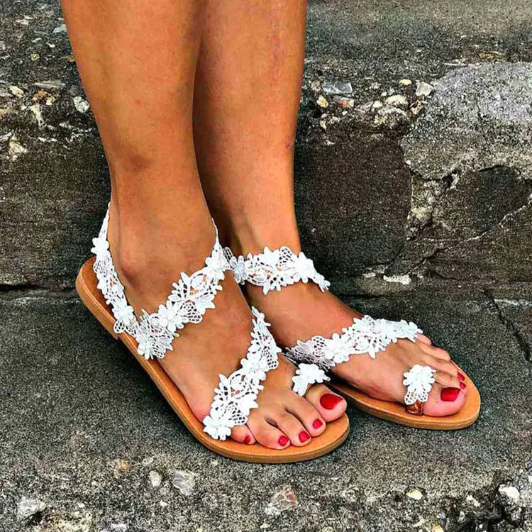 White women's flat shoes with rhinestone flower decoration on patent leather upper
