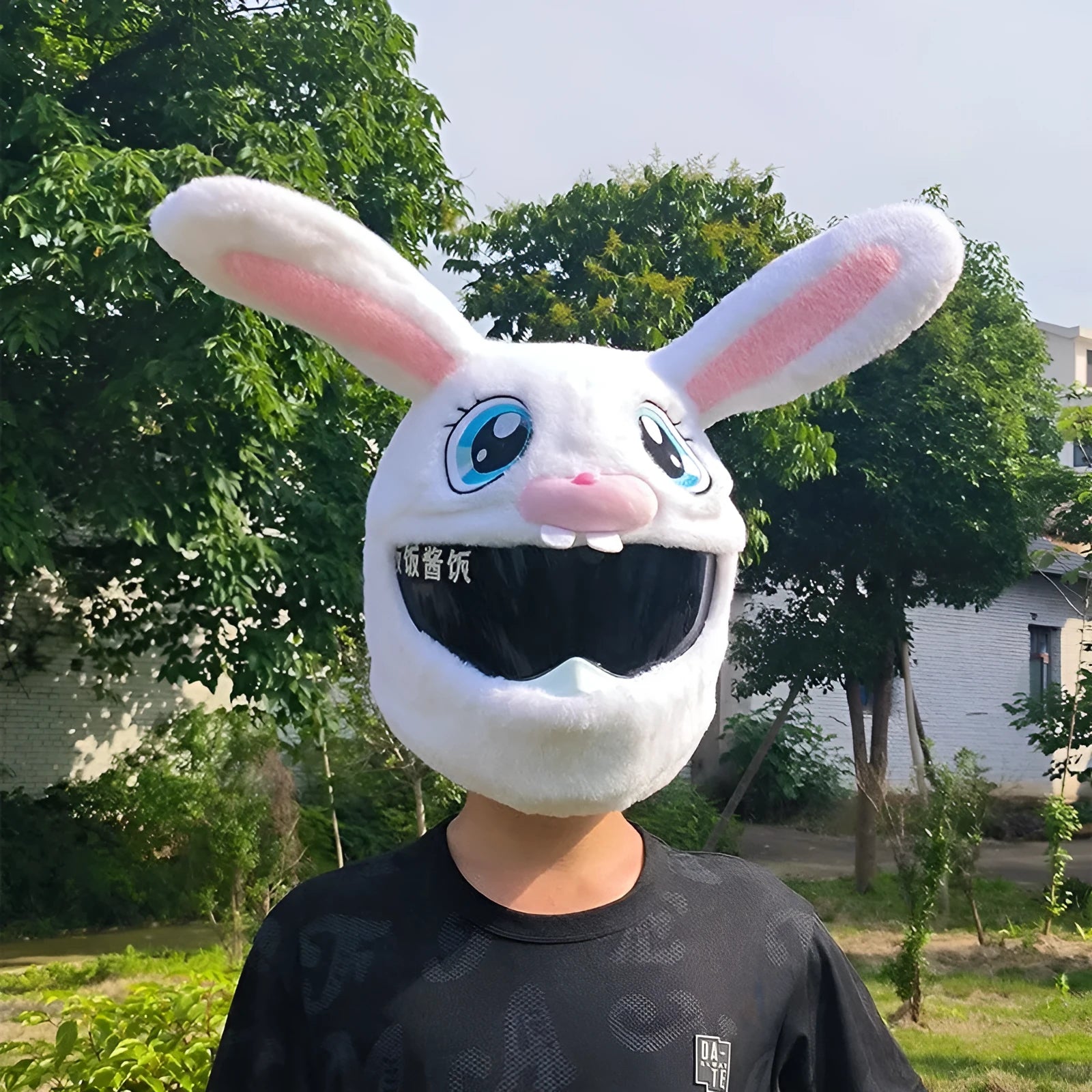 Long eared white rabbit plush cover on an electric motorcycle helmet.