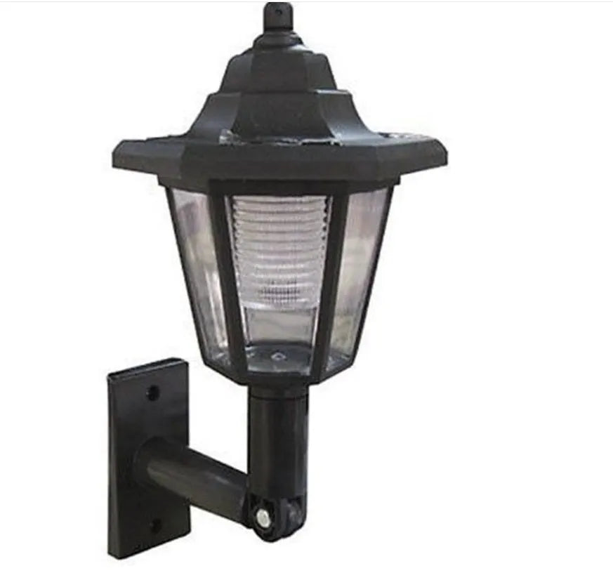 Black hexagonal solar wall lamp with integrated solar panel for outdoor garden or patio lighting