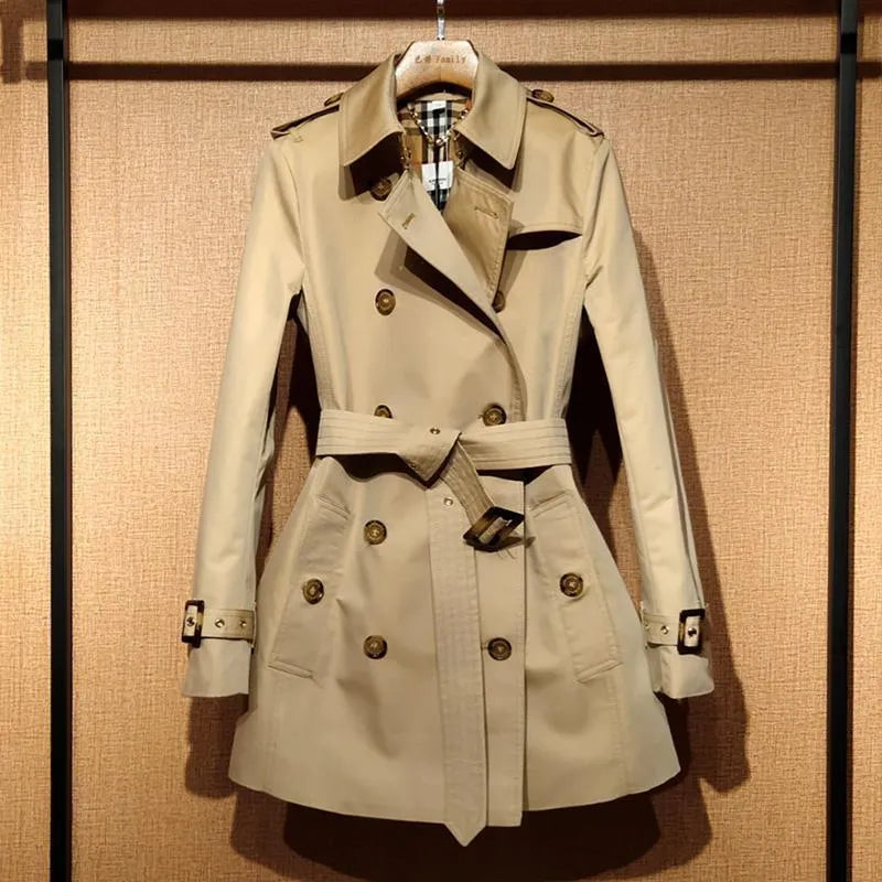 Khaki women's double breasted trench coat with flight sleeves and button detailing.