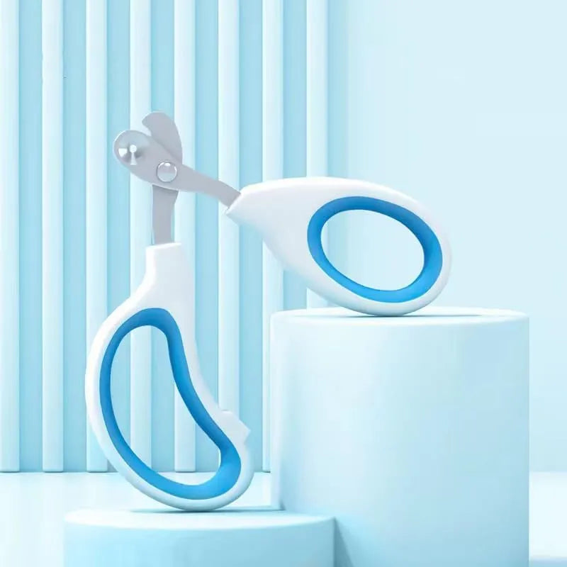 Blue pet nail clippers with circular cutting hole and cushioned handles on a white background