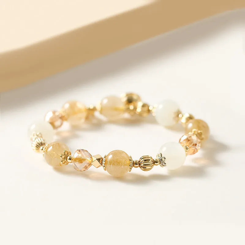 Gold rutilated quartz ringing bell bracelet with Korean style design and electroplated crystal construction