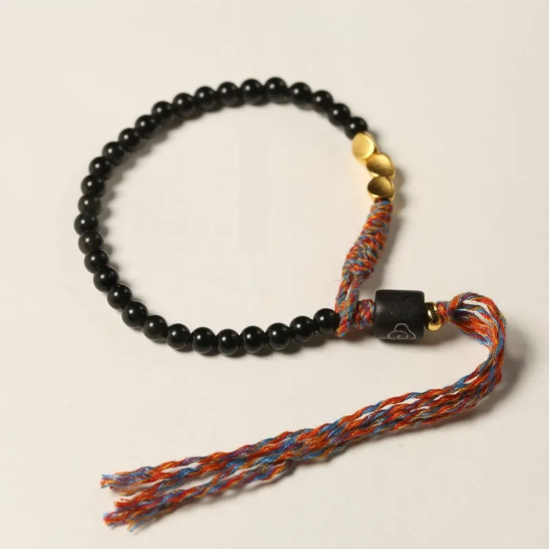 Hand-woven obsidian carrying strap bracelet showing textured detail and adjustable 15.5-16cm length