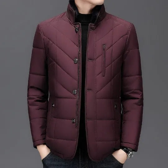 Men's dark blue short winter coat with side pockets and a full zip, showing cotton-padded construction.