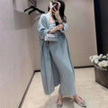 Women's grey knitted dress and matching coat suit with flocked pattern, long skirt, and regular sleeves.