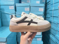 Classic brown and blue low-top casual trainers with flat rubber sole and lace-up front.
