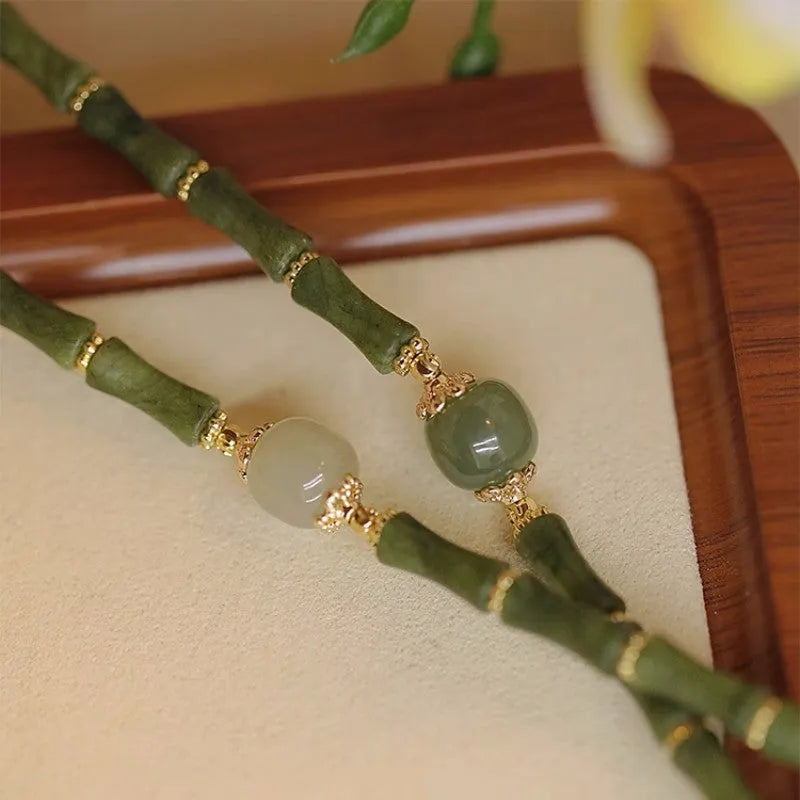 Hetian jade bracelet with geometric shape and round elements on female wrist