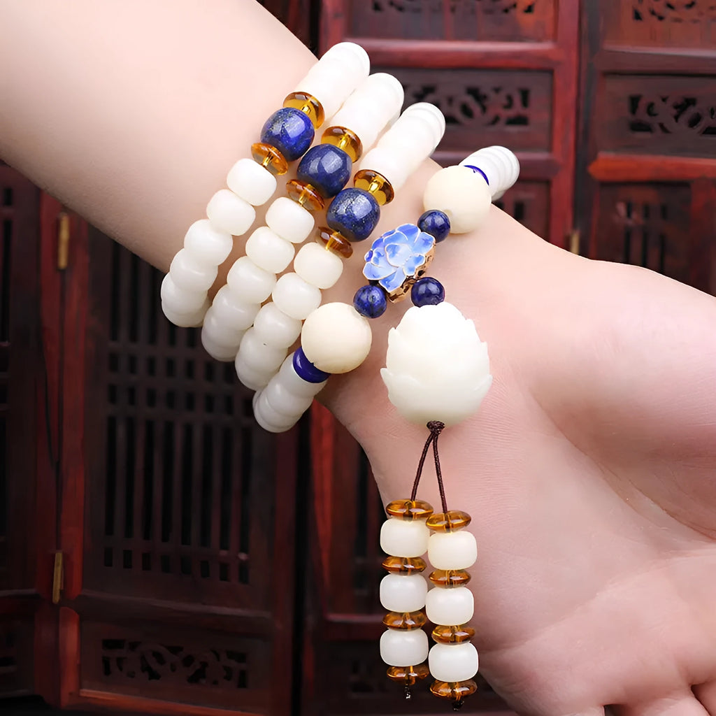 White jade Bodhi beads bracelet with 6x8mm beads in a choice of cloisonne, lotus, and tassel styles.