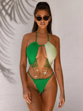 Green women's one-piece swimsuit with hollow design on mannequin