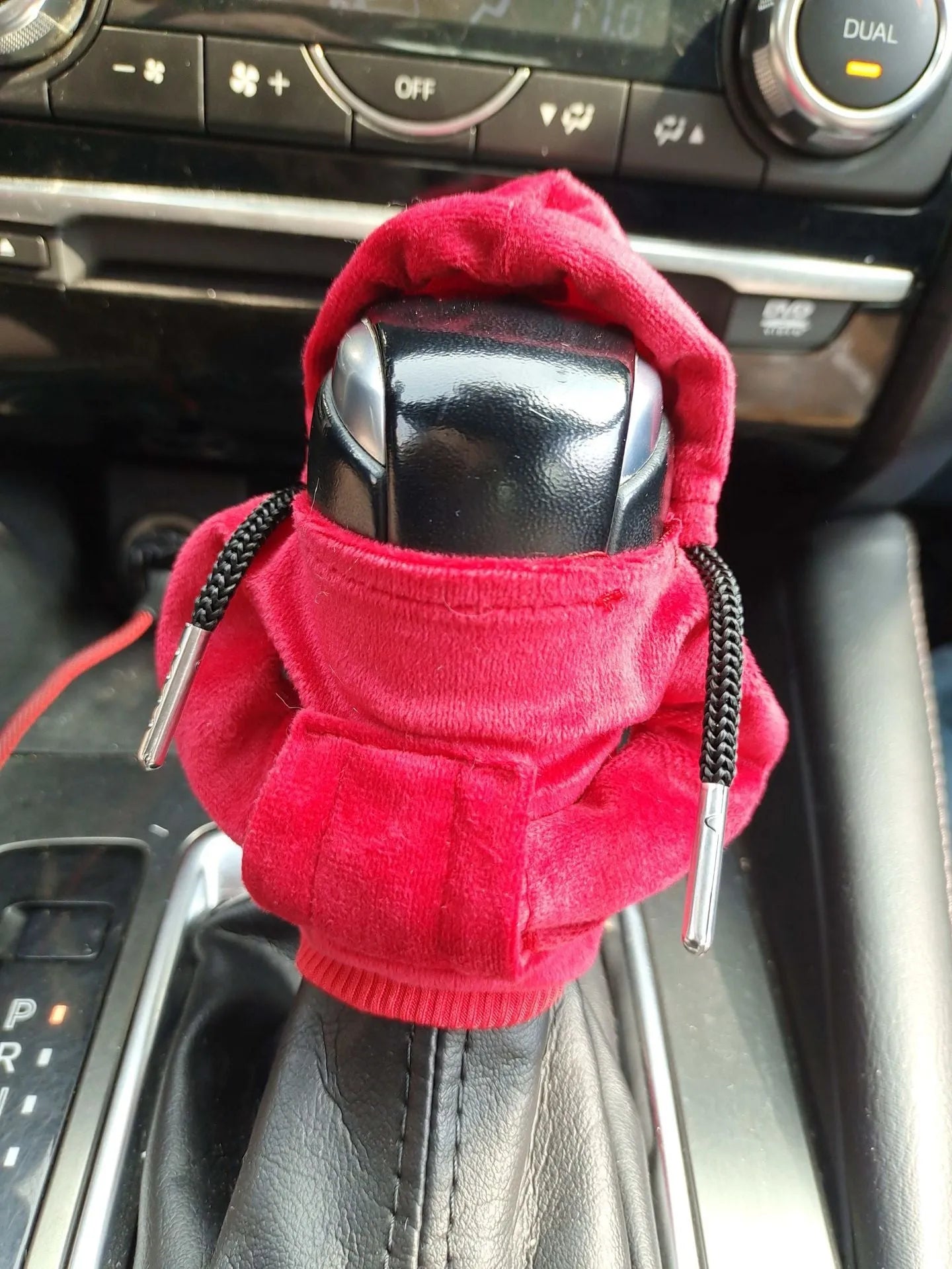 Pure cotton car gear lever sweater decoration in assorted colours on a gear stick.