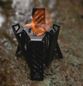 Hexagon alcohol camping stove showing foldable design and black/silver colour options
