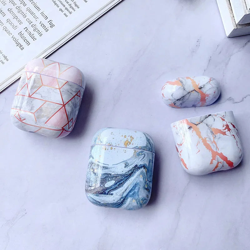 Hard white marble-pattern PC protective case fitted on an AirPods wireless earbud charging box.