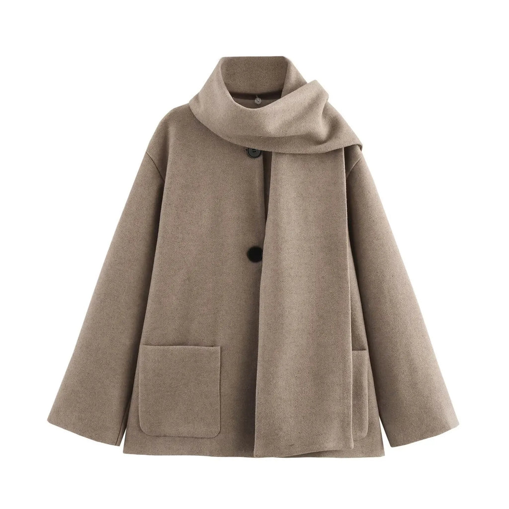 Women's long black polyester blend overcoat with a detachable artificial fur collar, showing pocket detail and street-fashion fit.