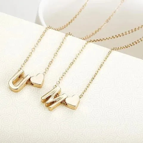 Peach heart shaped alloy pendant with a letter, in gold or silver finish, for necklaces.