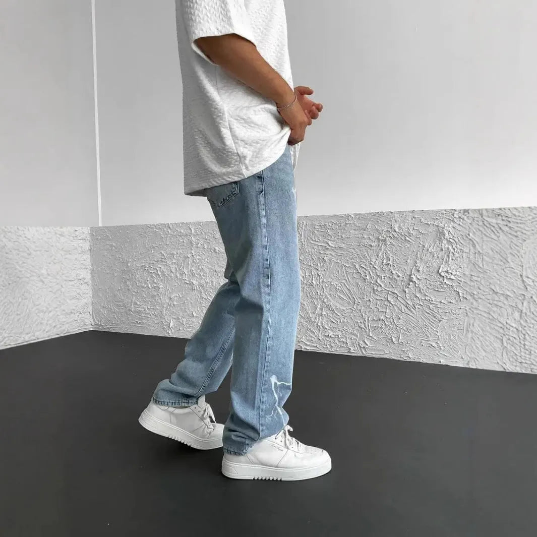 Men's blue straight-leg denim jeans with wide-leg silhouette and mid-waist design