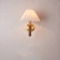 American retro wall lamp with a walnut wood base and white fabric shade mounted on a wall.