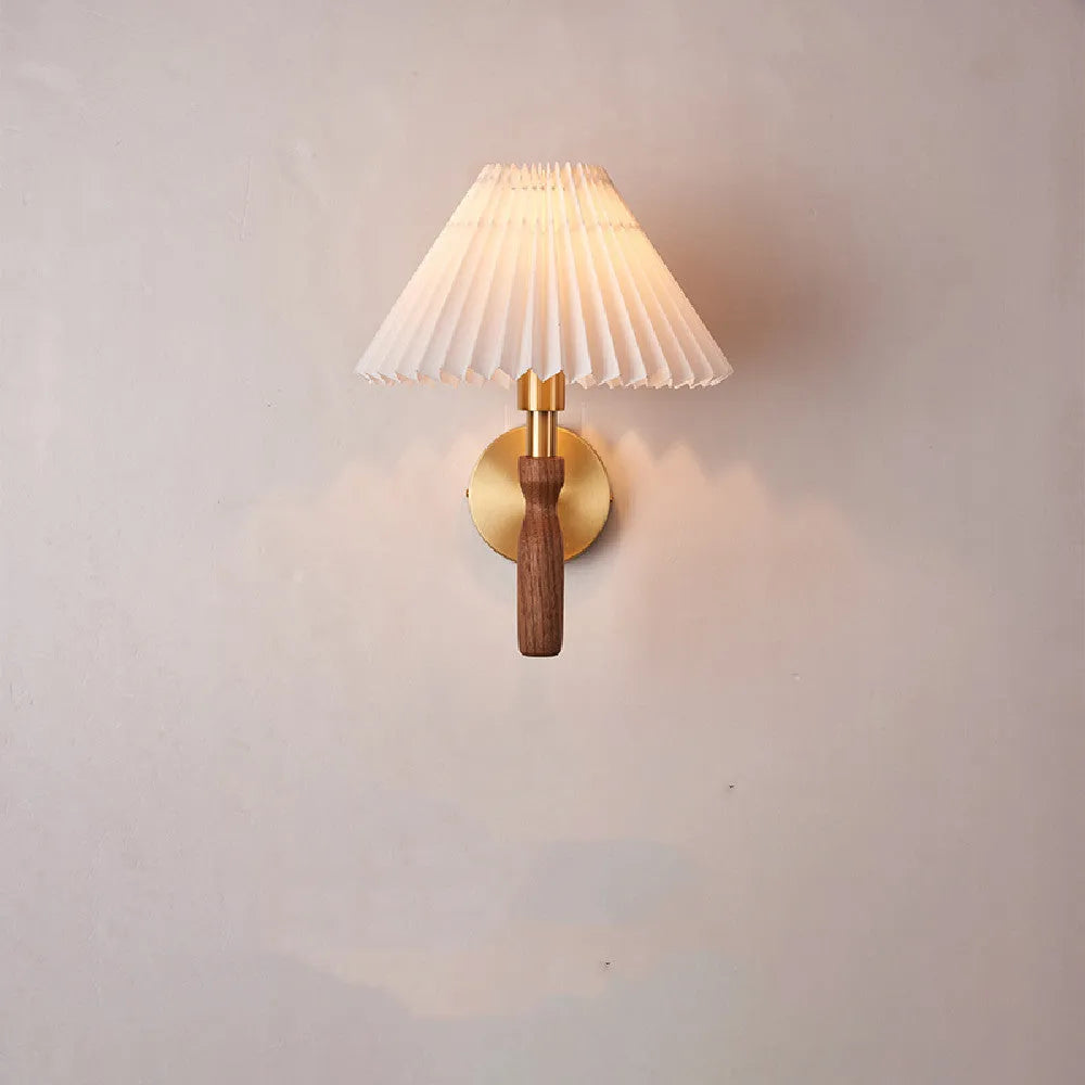 American retro wall lamp with a walnut wood base and white fabric shade mounted on a wall.