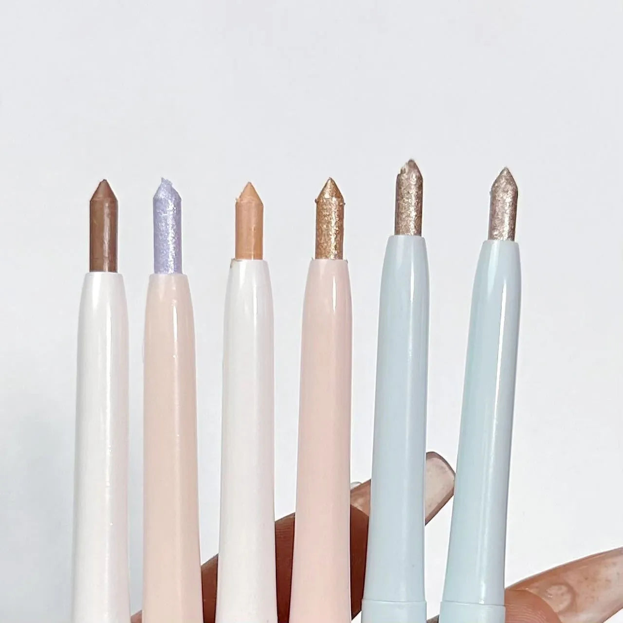 Waterproof 2-in-1 eyeshadow pen with six colour options showing camellia milk apricot and ice diamond debris shades