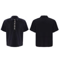 Black men's loose polo t-shirt with heavy embroidery sequins detail on the chest and a square collar.