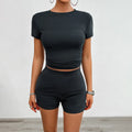 Womans solid colour slim-fit two-piece sport set with short sleeve t-shirt and elasticated shorts.