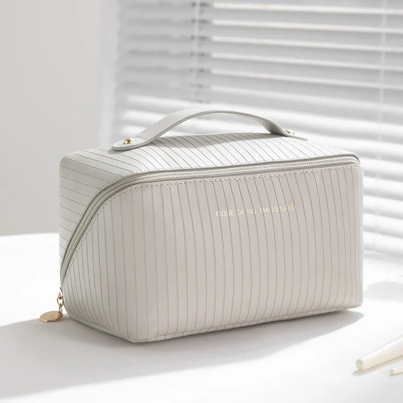 PU leather vertical pattern pillow makeup bag with cubic shape in travel setting