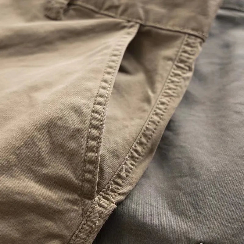 Men's khaki cotton trousers with multiple pockets and a cropped ankle length.