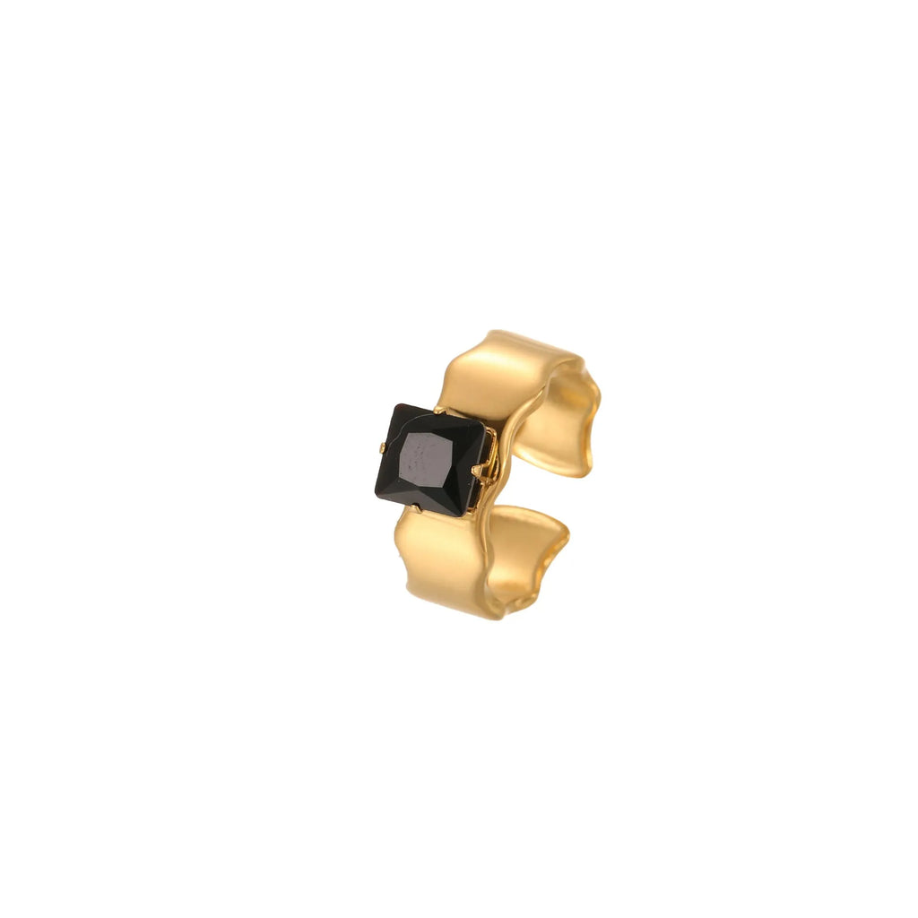 Geometric open mouth titanium steel ring for women with inlaid zircon stones on a grey background.