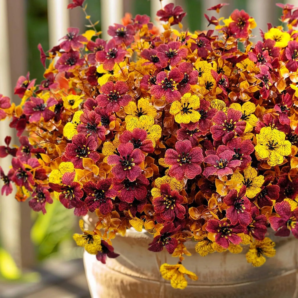 Artificial silk flower bouquet in autumn colours of red, yellow, and orange for wedding and home decoration