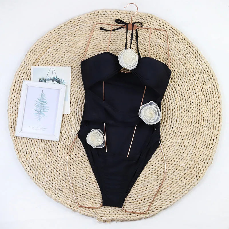Women's black one-piece swimsuit with 3D floral appliqué on the front