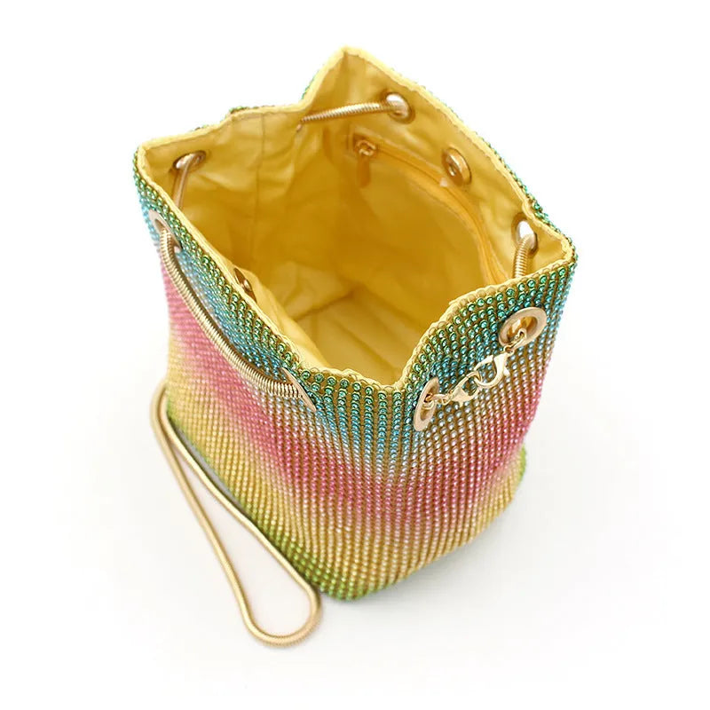 Sparkling rhinestone bucket handbag with a soft, unstructured shape on a neutral background.