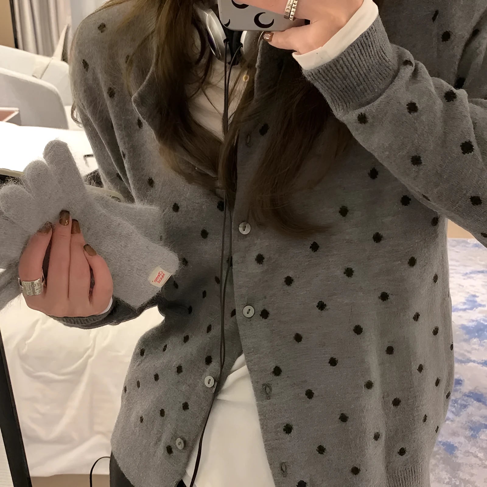Women's grey knitted cardigan with long sleeves and white crocheted flower details on the front.