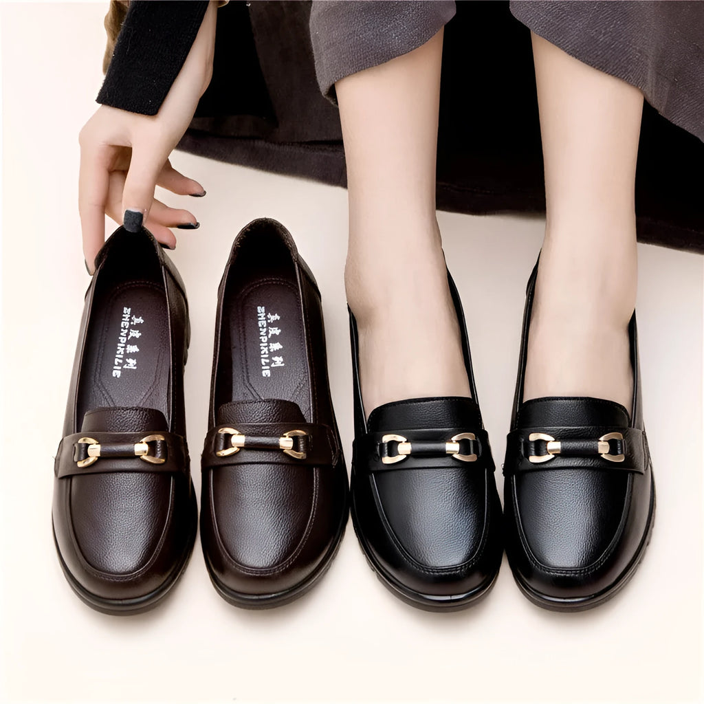 Black women's soft leather casual pumps with a low flat heel and round toe.