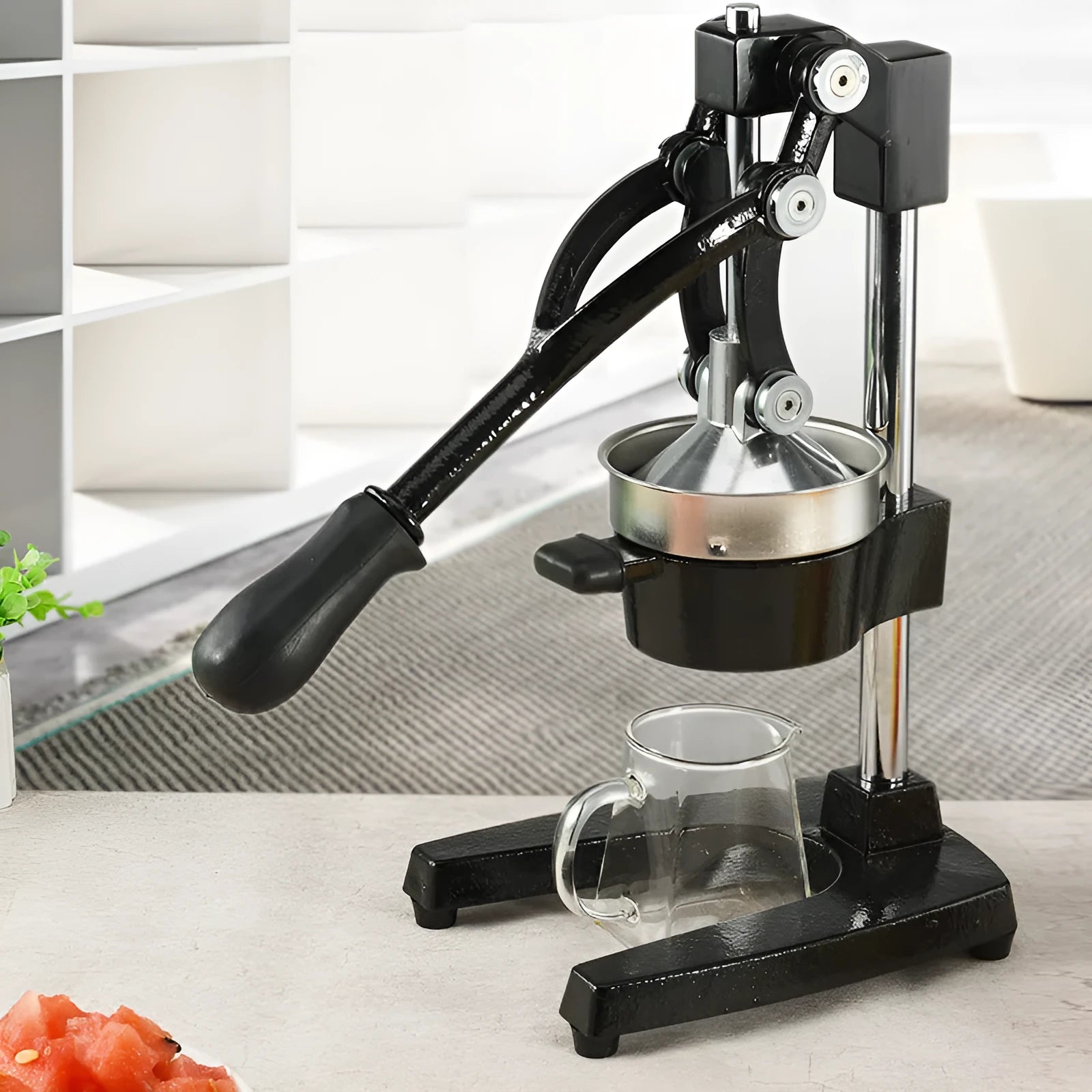 Cast iron manual citrus juicer with stainless steel strainer in black or white finish