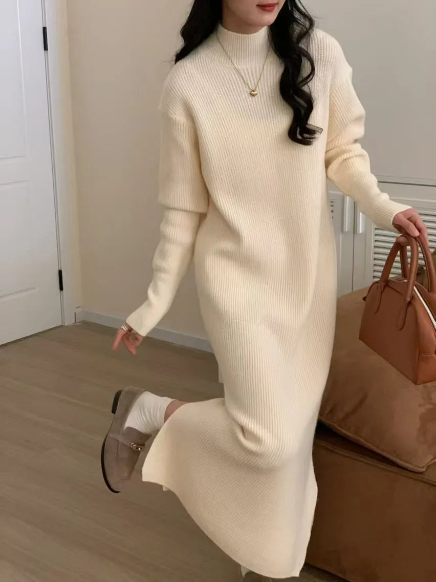 Half turtleneck long sleeve knitted dress in a solid colour, shown in a high-waisted midi length.