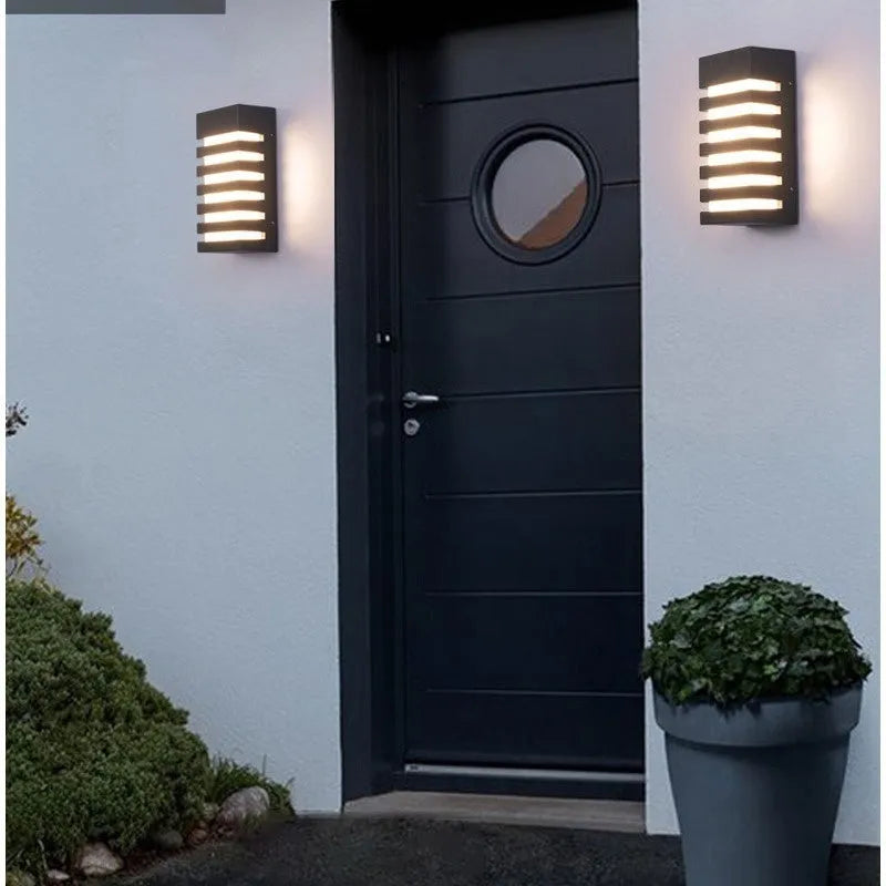 Modern minimalist outdoor wall lamp with aluminium shell and rectangular light panel.