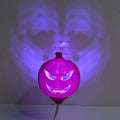 Plastic pumpkin-shaped decorative lamp with USB charging port, shown with purple or yellow light option.