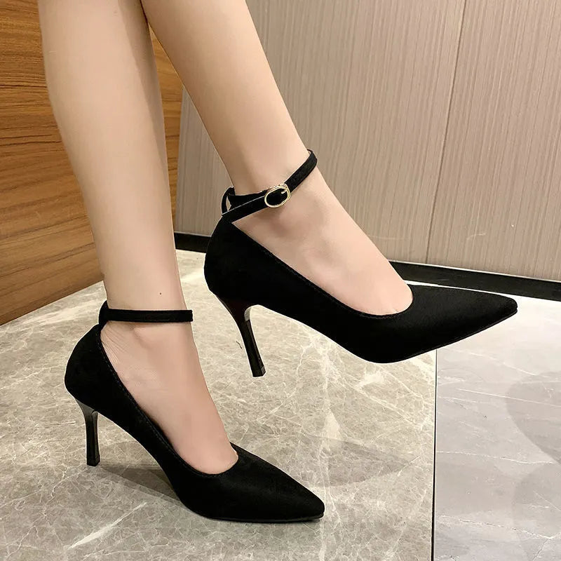 Women's black stiletto heels with skull pattern and buckle detailing on stiletto heel