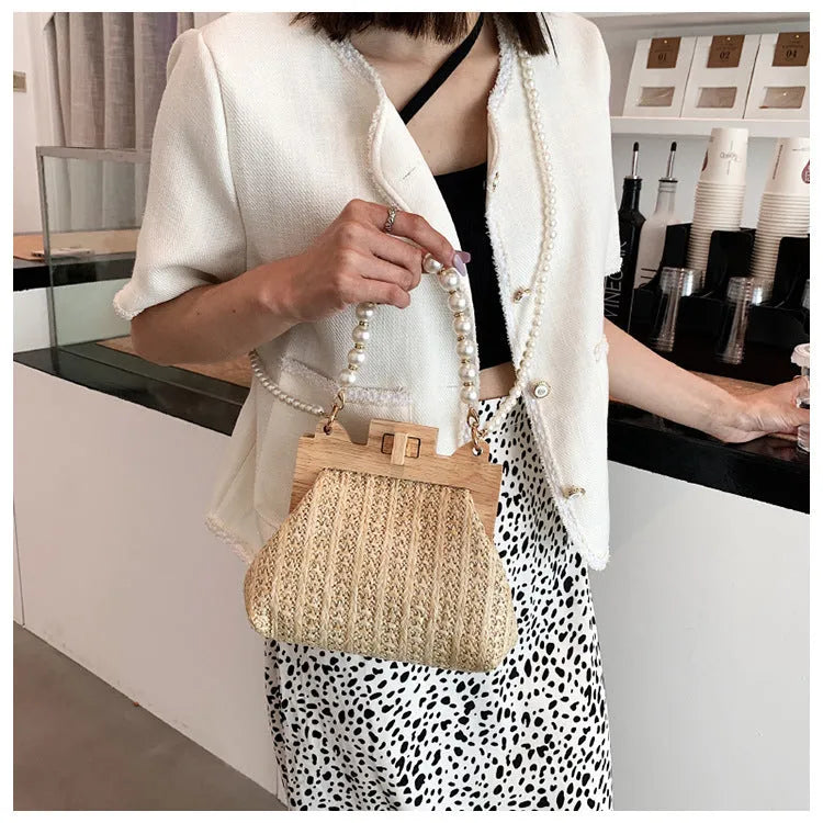 Women's straw woven shoulder bag with pearl chain strap in horizontal square shape