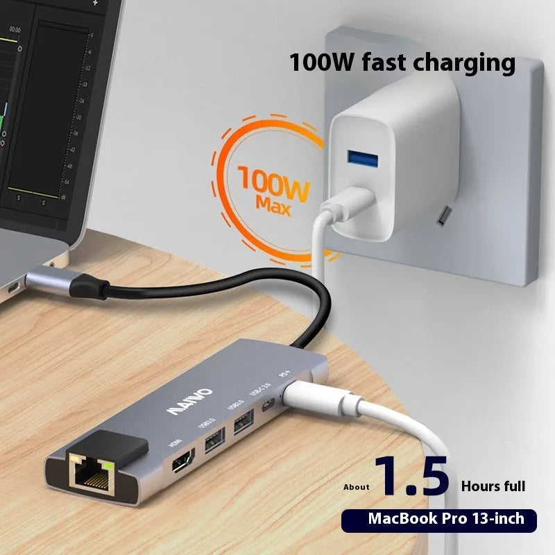 Aluminium Steam Deck six-in-one docking station with HDMI, USB, and Ethernet ports next to a handheld console.