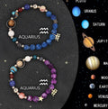 Two natural stone beaded bracelets with zodiac charms on a wooden surface, showing adjustable knot closures.