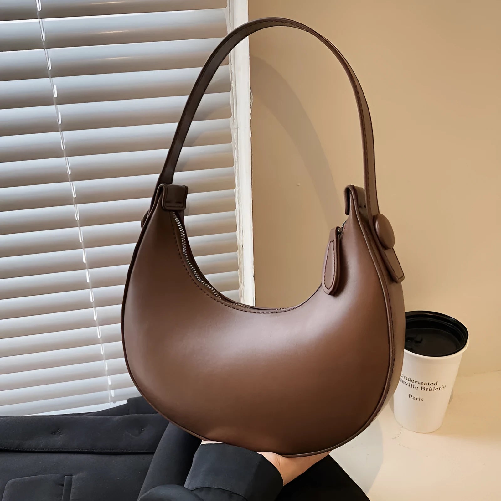 Women's retro dumpling-shaped shoulder bag in PU leather, shown in black, featuring an outer sandwich pocket.