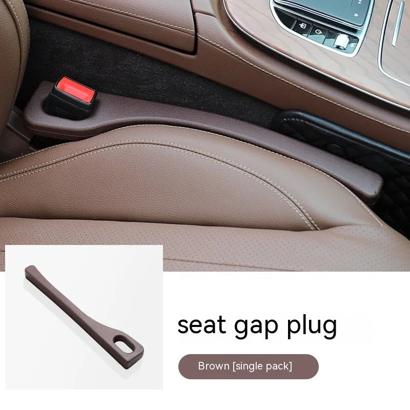 A pair of polyurethane car seat gap strips in beige colour on a car seat.