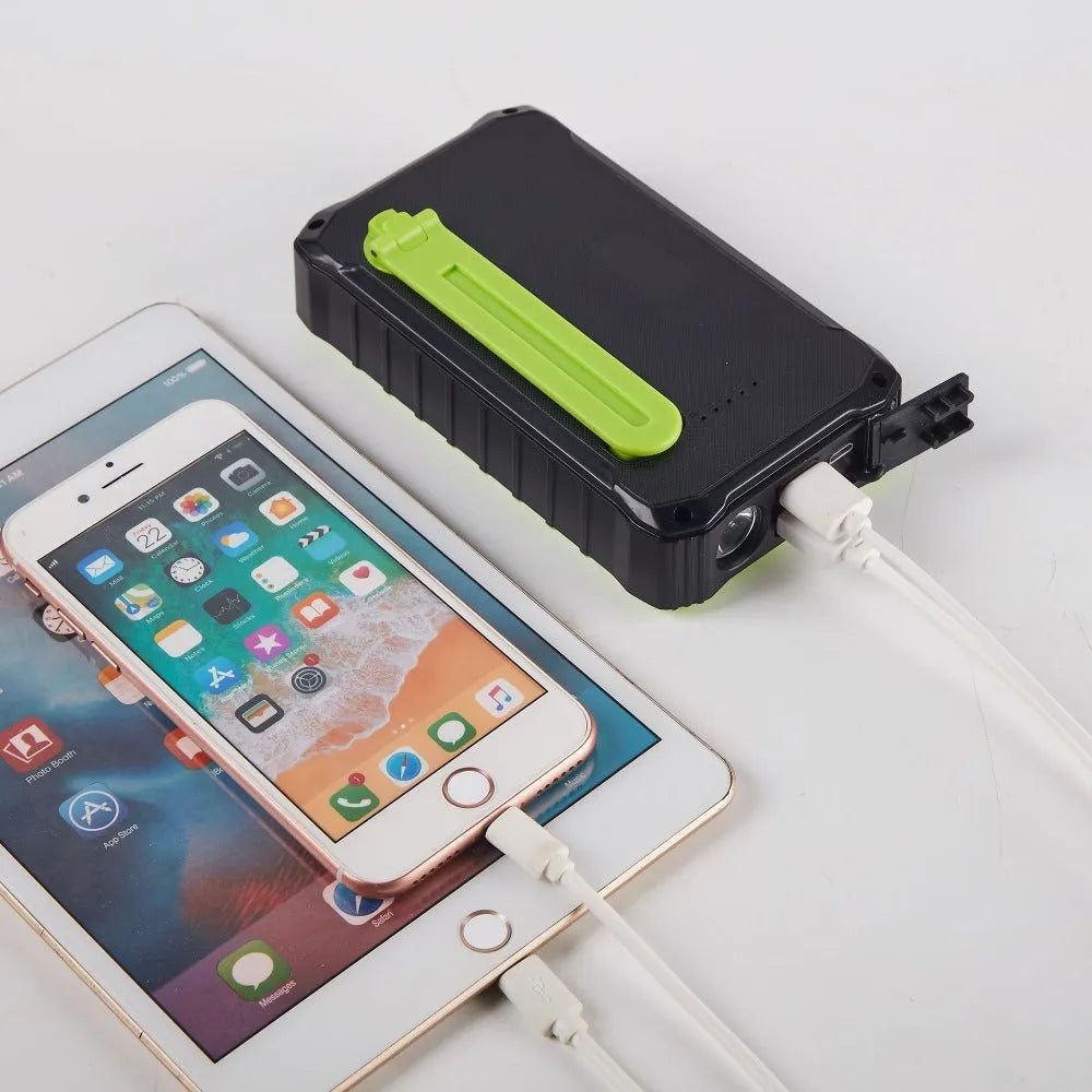 Green or orange hand solar mobile power bank showing dual USB ports and solar panel