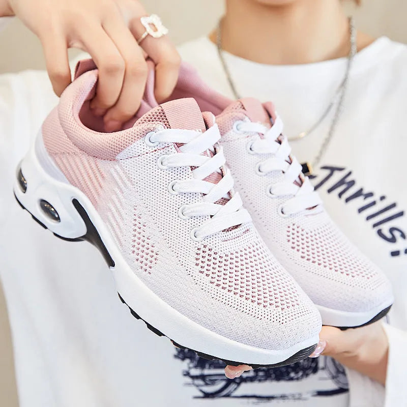 Women's striped Flyknit casual running shoes in pink with a round toe and flat PVC sole.
